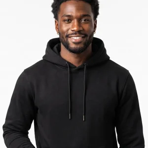 male model with brown skin wearing a black hoodie against a white background.